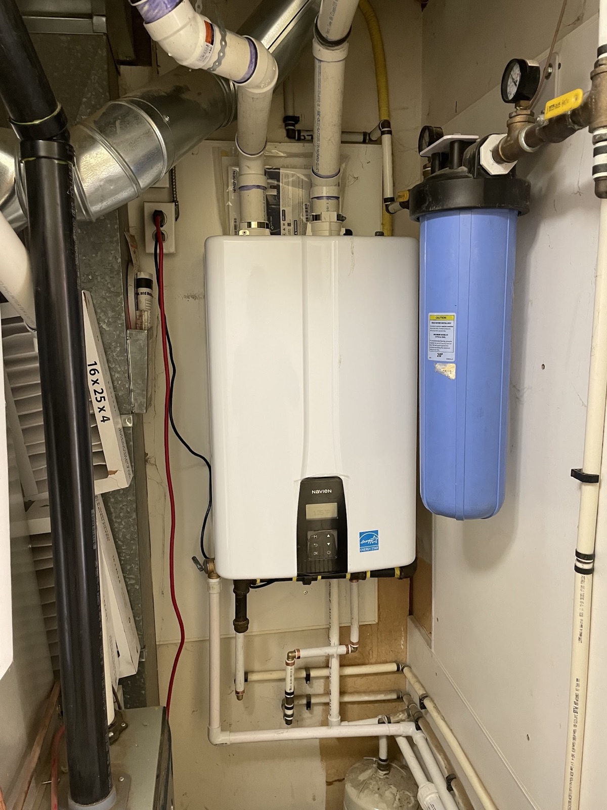 Navien tankless water heater with venting piping and water filtration